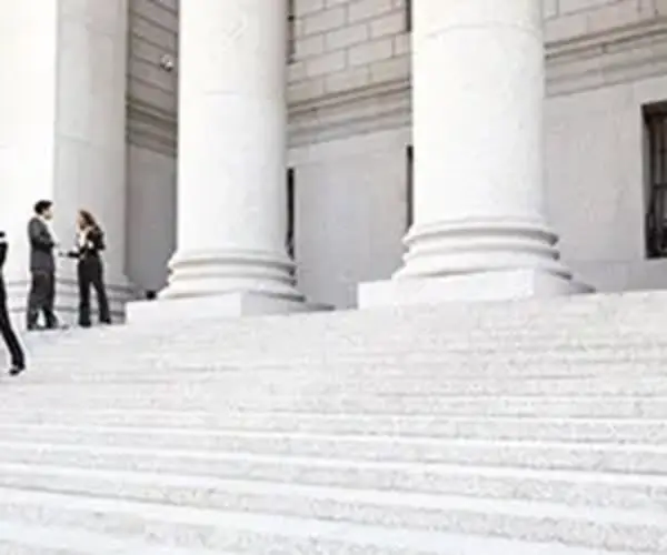 lawyers standing on courtroom steps trial litigation