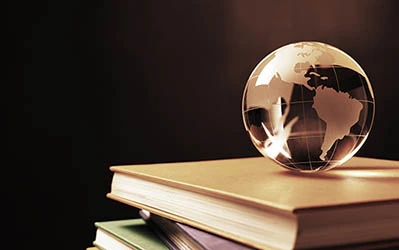 globe of the world on a stack of books